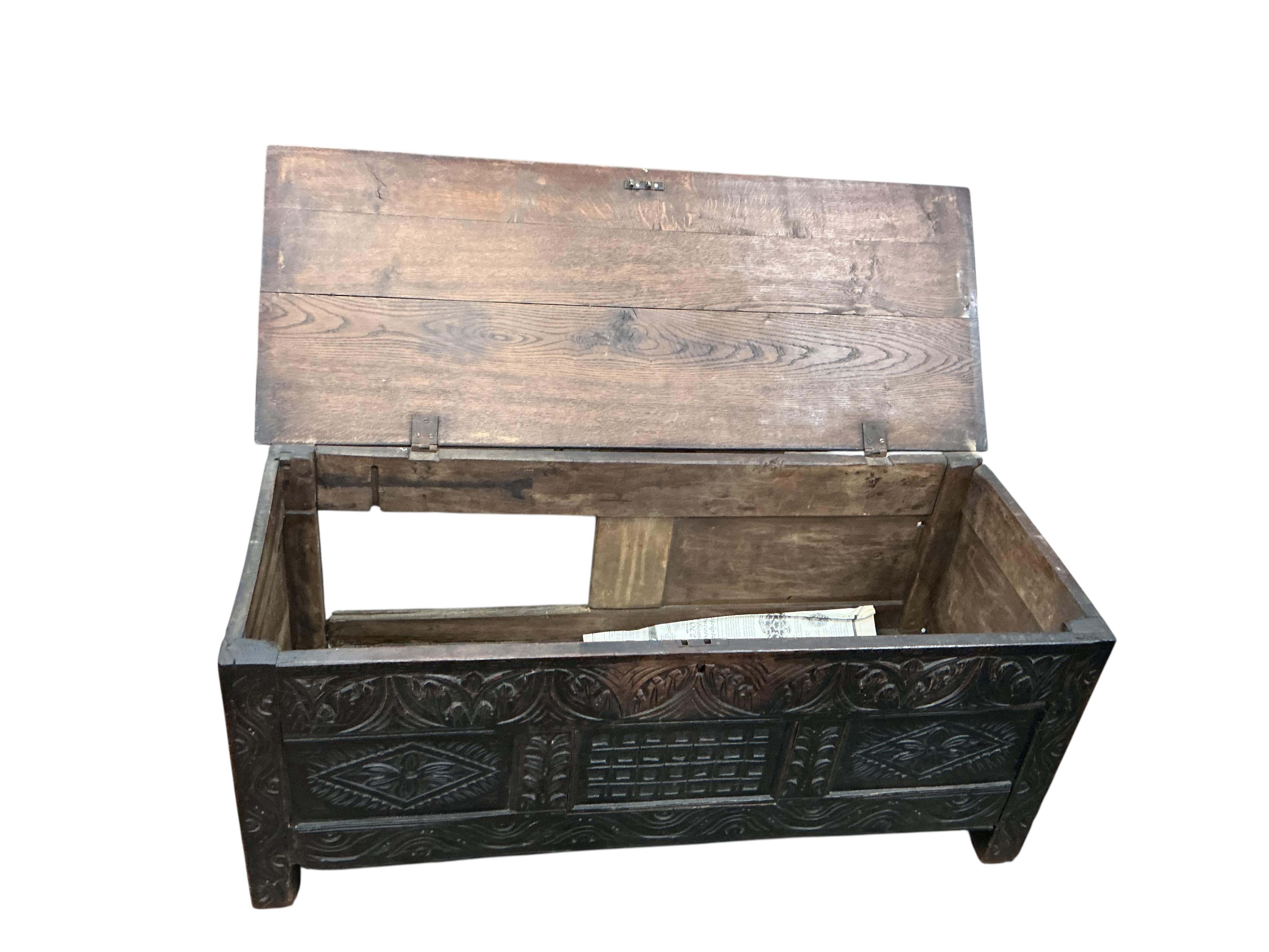 An 18th century panelled oak coffer, width 136cm, depth 54cm, height 56cm